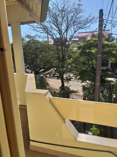 a balcony with a view of a tree at casa das flores in Canoas