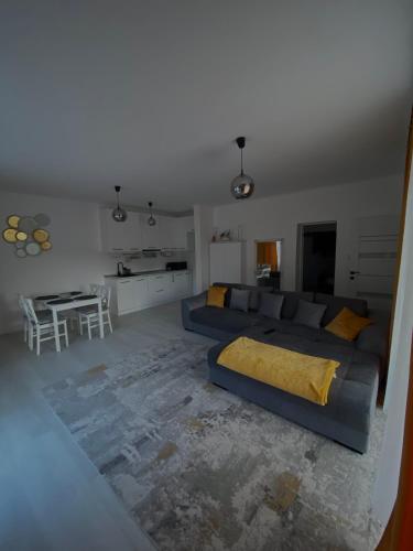 a living room with a blue couch and a table at Casa Mimi in Oradea