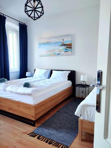 a bedroom with a large bed with white sheets at Apartman Rijeka centar in Rijeka