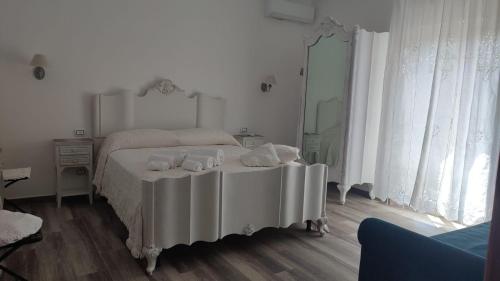 a bedroom with a bed with a table with dishes on it at Cristalli di Keli in Santa Elisabetta