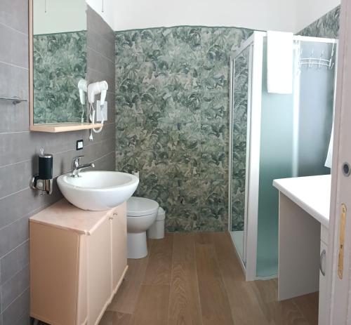 a bathroom with a sink and a toilet and a shower at Cristalli di Keli in Santa Elisabetta