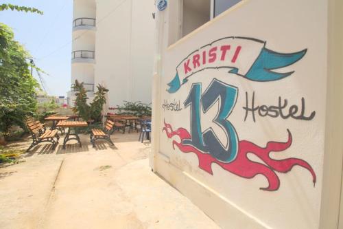 a sign on the side of a building at Hostel K13 in Sarandë