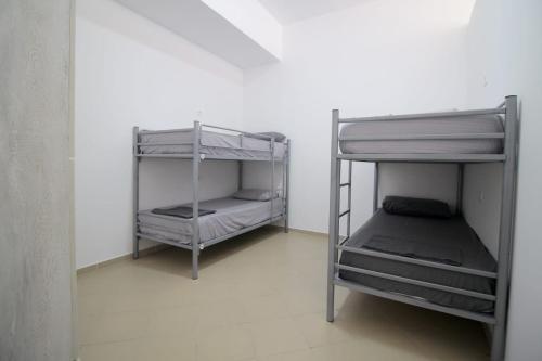two bunk beds in a room with a wall at Hostel K13 in Sarandë