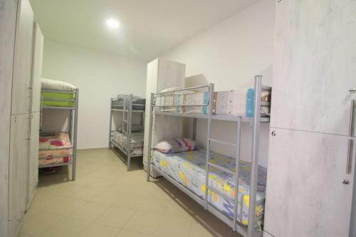 a room with several bunk beds in a room at Hostel K13 in Sarandë
