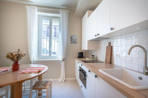 une cuisine blanche avec un évier et un comptoir dans l'établissement Studio - Calme - à 700m de la plage et calanques, à Marseille