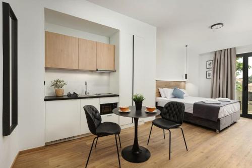 a room with a bed and a table and chairs at The Meta Stay-Rooftop Access Sunny Suite in Athens