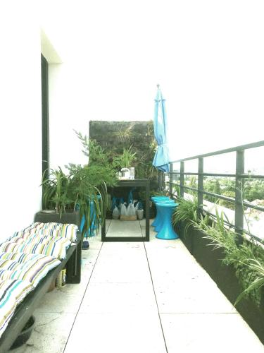 un patio avec des bancs et des plantes dans un bâtiment dans l'établissement Superbe ROOF-TOP avec vue 360°, à Colombes