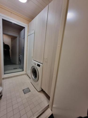 a bathroom with a washer and dryer in a room at Villa Haawe in Syöte