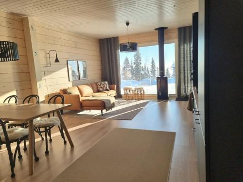 a living room with a couch and a table at Villa Haawe in Syöte