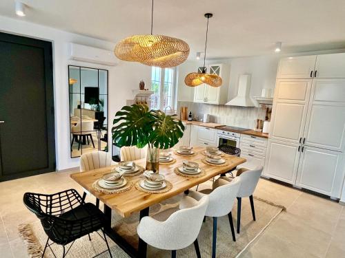 a kitchen with a wooden table and white cabinets at Casa Katarina in Novalja
