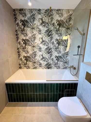 a bathroom with a bath tub and a toilet at Casa Katarina in Novalja