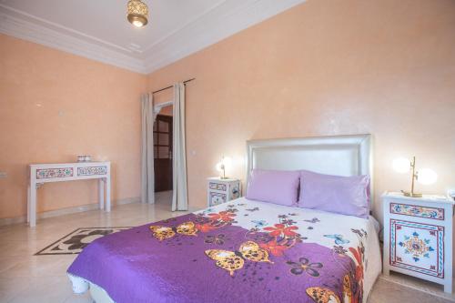 a bedroom with a bed and two night stands at Villa en pleine campagne avec vue sur l'atlas in Marrakech