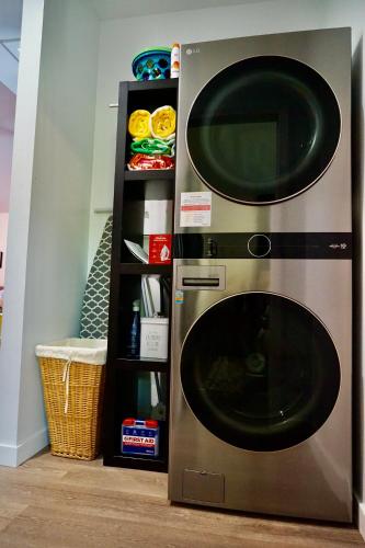 a microwave oven sitting next to a shelf at Newly Built, Bright, and Modern Guest Home in San Diego