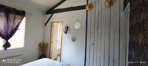 a bedroom with a wooden door and a window at Maison climatisée proche du lac in Sanguinet