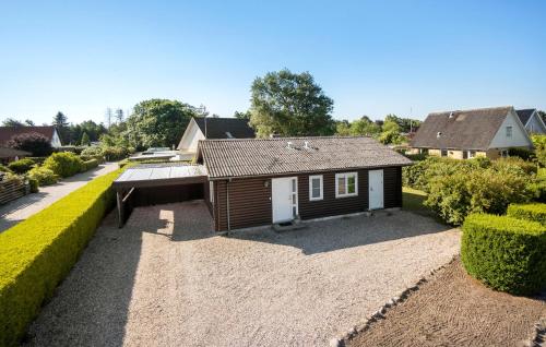 a small house in a yard with a courtyard at 3 Bedroom Lovely Home In Millinge in Millinge