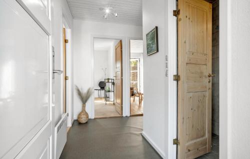 a hallway with white walls and a wooden door at 3 Bedroom Lovely Home In Millinge in Millinge
