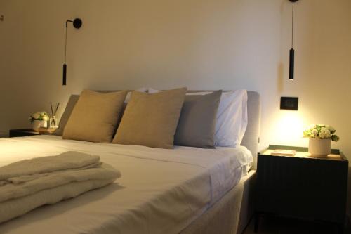 a bed with white sheets and pillows in a room at Villa Paladino in Ioppolo
