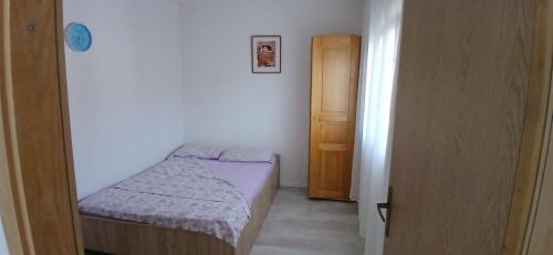 a small bedroom with a small bed and a small door at Sara&Sami in Mostar