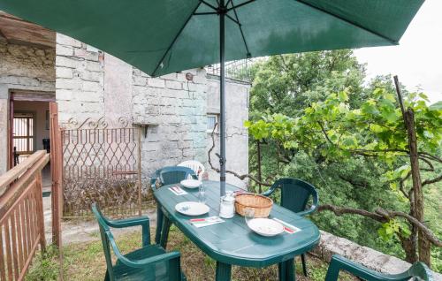 a blue table with chairs and an umbrella at 3 Bedroom Stunning Home In Roccaberardi in Collipace
