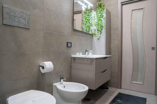 a bathroom with a white toilet and a sink at Casa Vacanze Villa Esterina in Ercolano