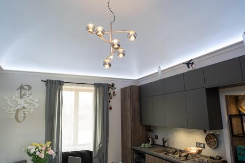 a kitchen with a chandelier hanging from a ceiling at Casa Vacanze Villa Esterina in Ercolano