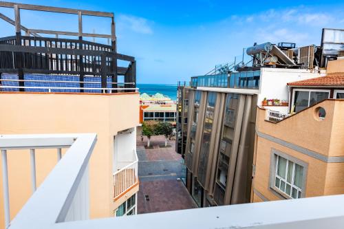 an apartment balcony with a view of the ocean at Calas Beach Corralejo in Corralejo