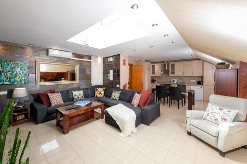 a living room with a couch and a table at Calas Beach Corralejo in Corralejo
