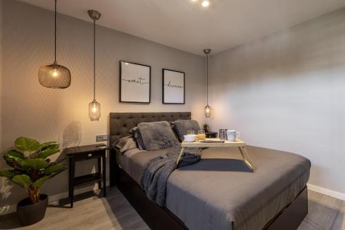 a bedroom with a bed with a table on it at Holyhome cucharas beach in Costa Teguise