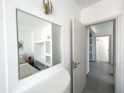 a bathroom with a large mirror on the wall at Antiparos Diamond in Antiparos Town