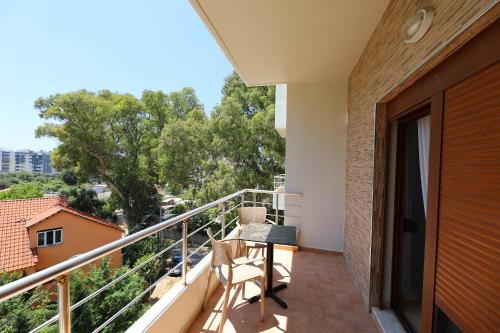 a balcony of a house with a table and chairs at Hotel Erjuma in Vlorë