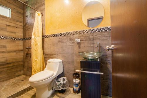 a bathroom with a toilet and a sink at Quinta San Carlos Ensenada in Ensenada