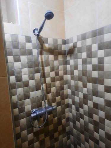 a shower in a bathroom with a tiled wall at Amsa Tetouan in Chozas
