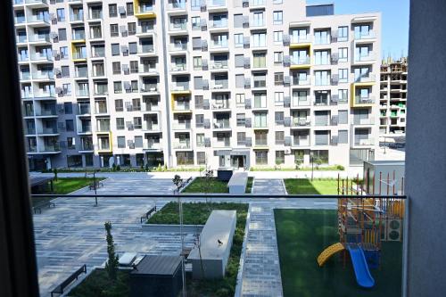 a large apartment building with a playground in front of it at Apartment Skopje in Skopje