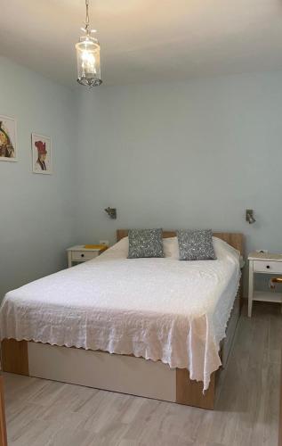 a bedroom with a bed with two pillows on it at Villa Rosa, Dracevica 46a, Brac in Dračevica
