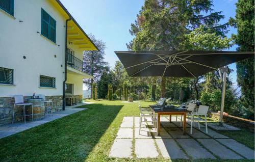 a patio with a table and an umbrella at Cozy Home In Marsaglia With Kitchen in Marsaglia