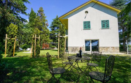a table and chairs in front of a house at Cozy Home In Marsaglia With Kitchen in Marsaglia