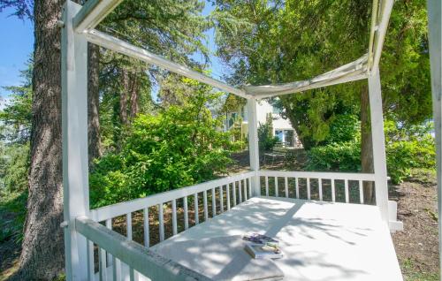 a gazebo with a bench on a porch at Cozy Home In Marsaglia With Kitchen in Marsaglia