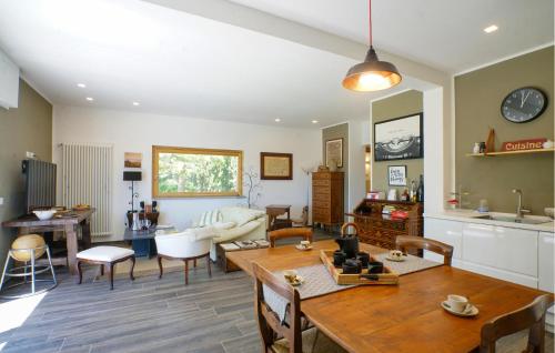 a living room with a table and chairs at Cozy Home In Marsaglia With Kitchen in Marsaglia