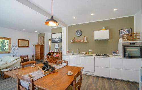 a kitchen and living room with a table and a couch at Cozy Home In Marsaglia With Kitchen in Marsaglia
