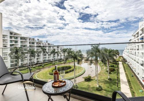 a balcony with a table with wine glasses on it at Hermoso departamento, Vista al mar, 2 recámaras 516 in Nuevo Vallarta