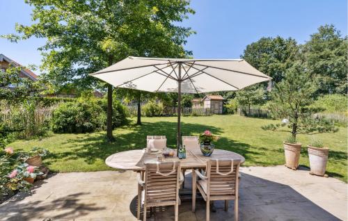 a table and chairs under an umbrella in a yard at Cozy Home In Warendorf With Wifi in Warendorf