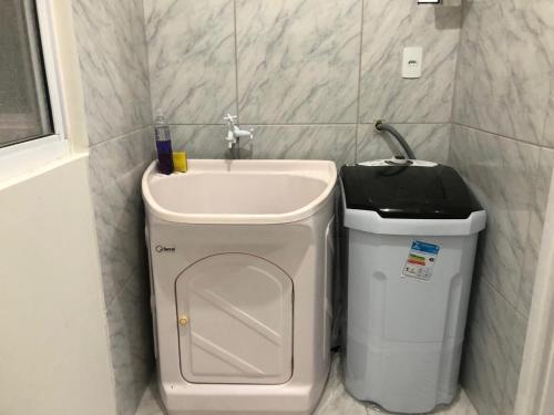 a bathroom with a sink and a trash can at Apartamento Laguna in Laguna