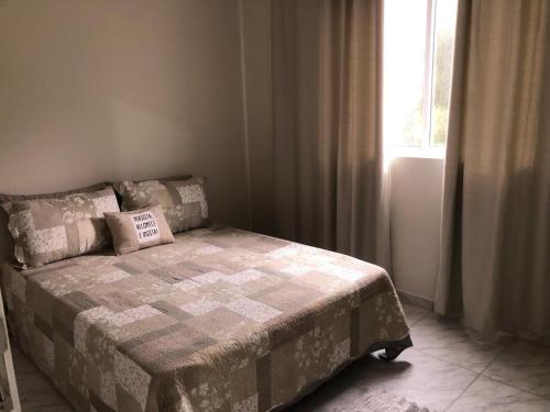 a bedroom with a bed with a pillow on it at Apartamento Laguna in Laguna