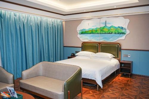 a bedroom with a bed and a chair and a couch at Nost algia S Hotel Hangzhou West Lake & Lingyin Temple 时光漫步S酒店杭州西湖店 Free laundry service, Free fresh ground coffee in Hangzhou