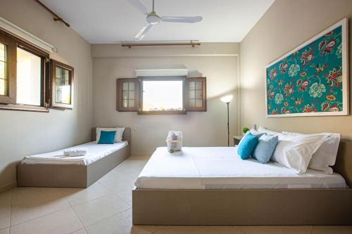 a bedroom with two beds and a painting on the wall at Color Villa - South Paradise 2 in Himare