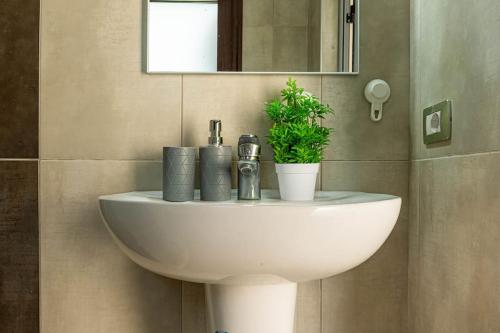 a white sink in a bathroom with a mirror at Color Villa - South Paradise 2 in Himare