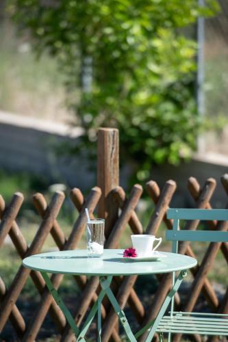 a table with two cups and a drink on it at Adam House-Castle view in Toroni