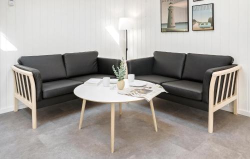a living room with a couch and a table at 4 Bedroom Lovely Home In Hals in Hals