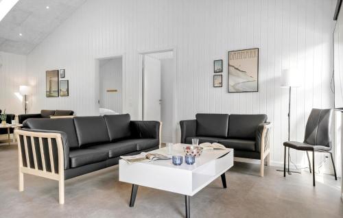 a living room with two couches and a coffee table at 4 Bedroom Lovely Home In Hals in Hals