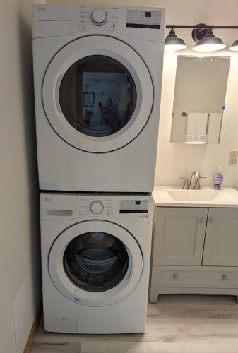 a washer and dryer in a bathroom with a sink at Bird House in Packwood